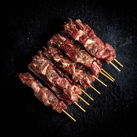 a close up of a grill with meat on it
