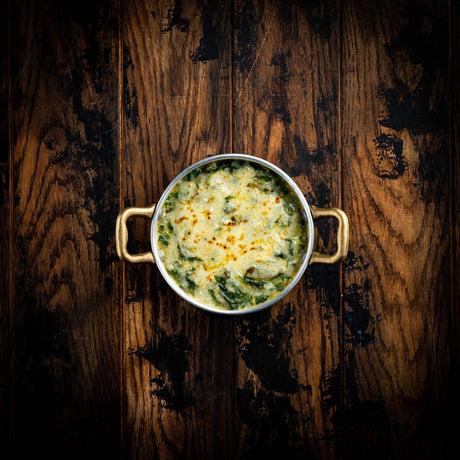 a bowl of soup and a bowl of broccoli