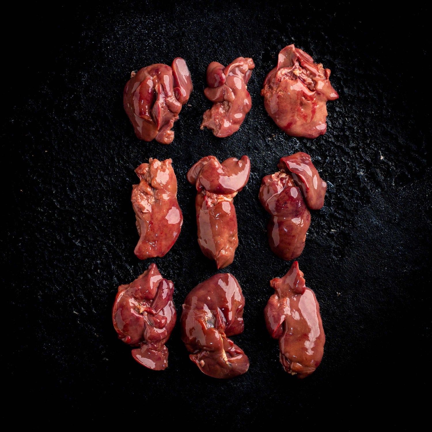 a group of teddy bears sitting on a black background