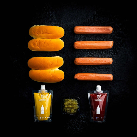 a bunch of hot dogs on a grill