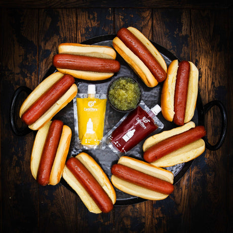 a bunch of hot dogs sitting on a table