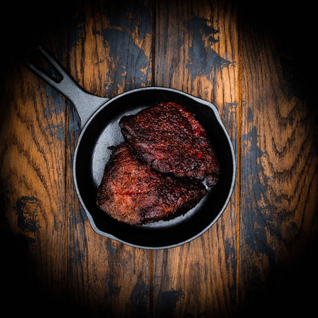 a close up of a plate of food on a wooden table
