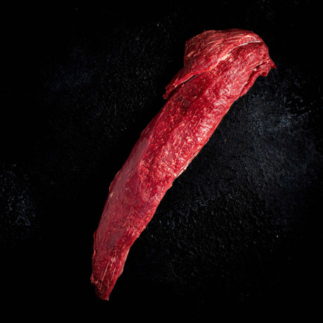 a person holding a red umbrella in the dark