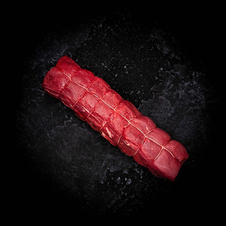 a red carrot is laying on a black background