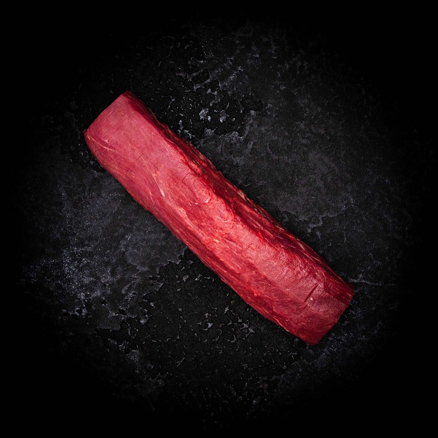 a red skateboard is laying on the ground