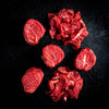 a bunch of red flowers sitting on a black background 