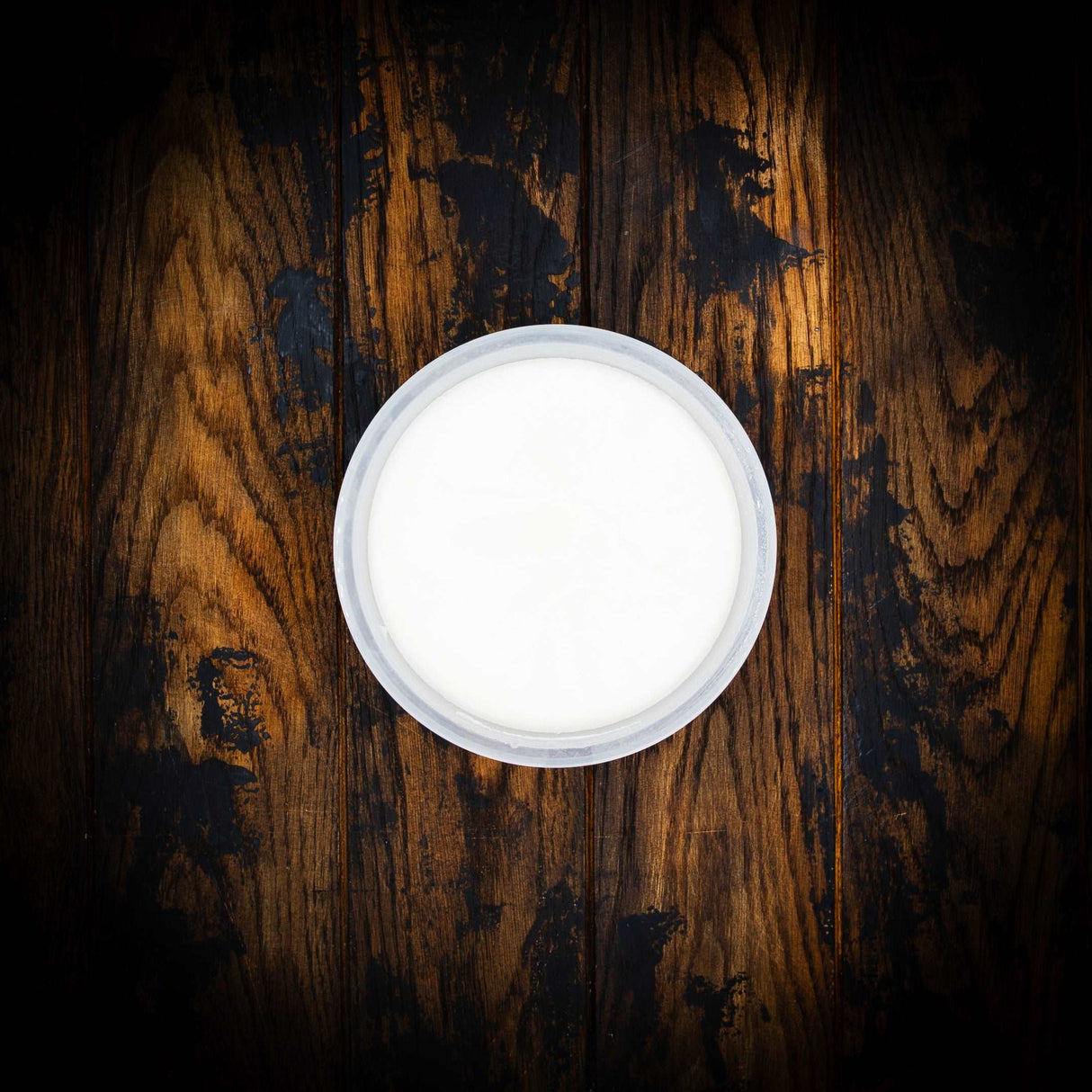 a white toilet sitting on top of a wooden table 