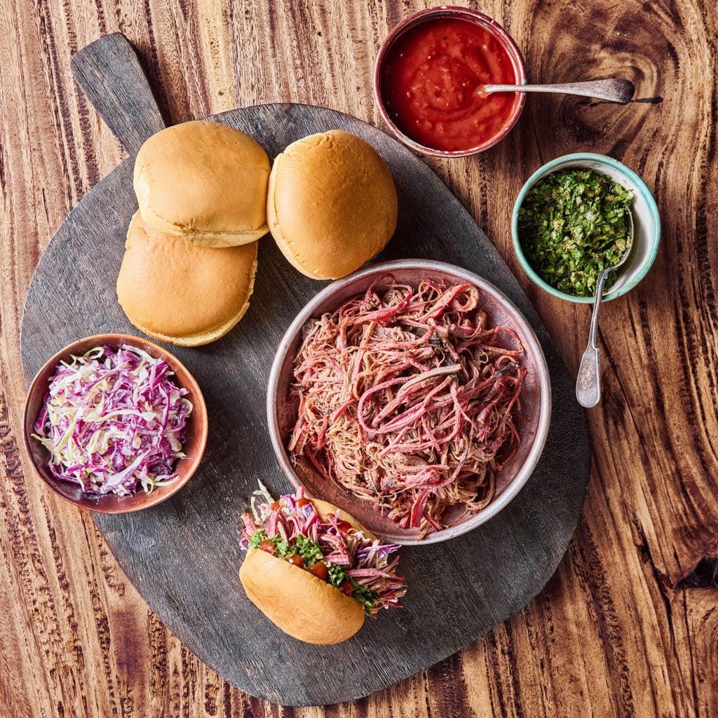 Platter with pulled brisket, buns, and condiments