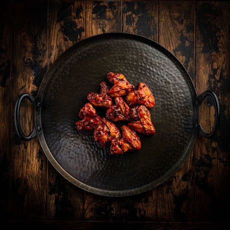 a pan of food cooking on a grill 