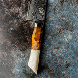 a close up of a knife on a cutting board 