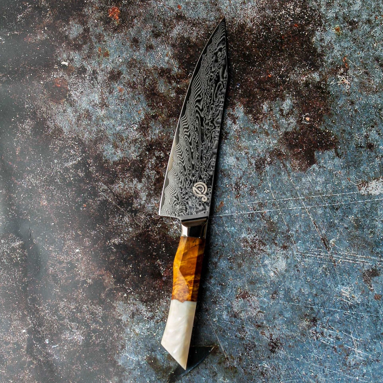 a close up of a knife on a surface 