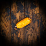 a yellow banana sitting on top of a wooden table 