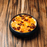 Wagyu ragu, rich with broth, tomatoes, and onions