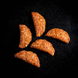 a group of peeled oranges sitting on a black background 