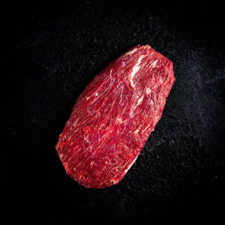 a red frisbee sitting on top of a black surface 