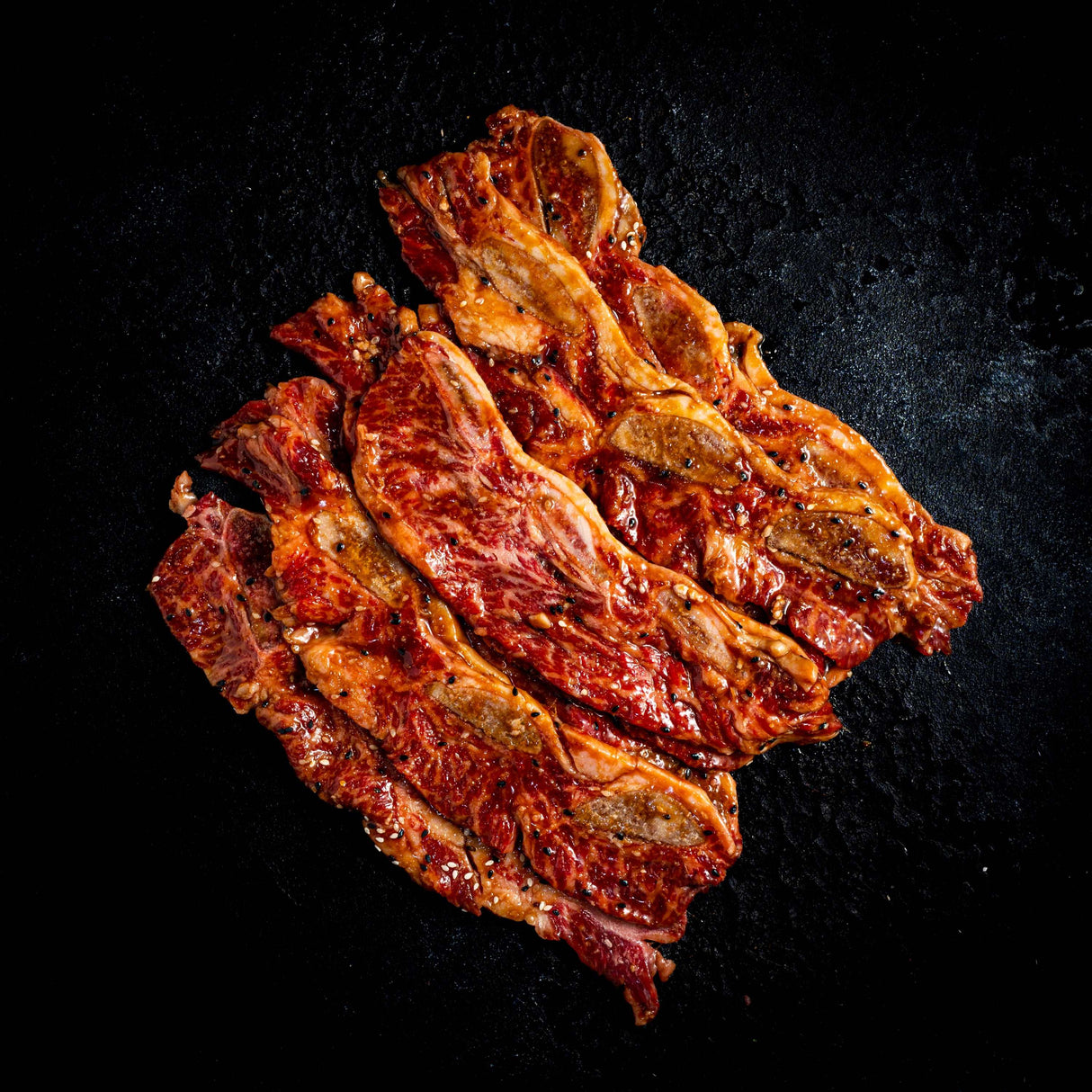 a close up of a plate of food on a black surface 