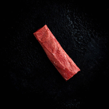 a red stop sign sitting in the dark 