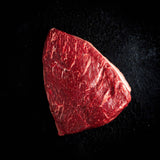 a red frisbee sitting on top of a black surface 