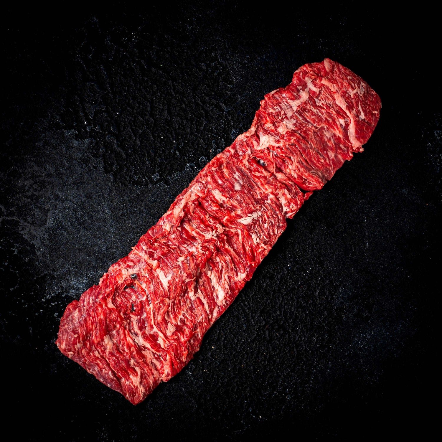 a close up of a red tie on a black background 