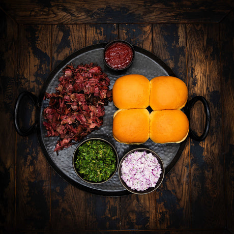 a bowl of fruit sitting on a wooden table 