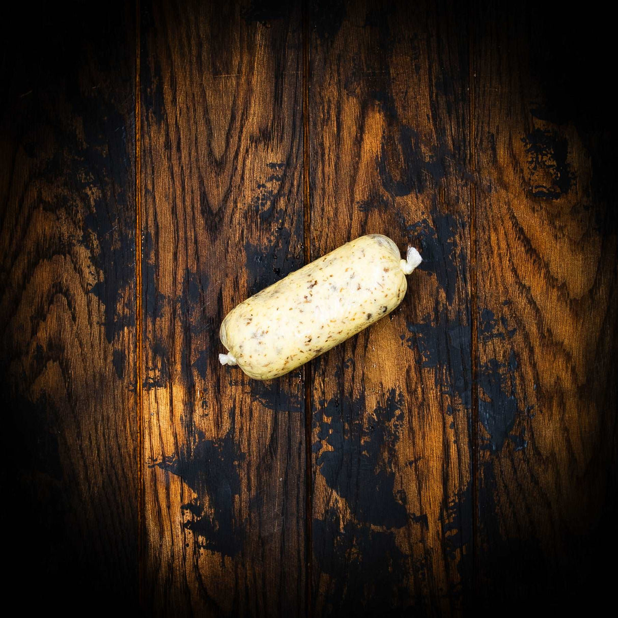 a broken surfboard laying on a wooden floor 