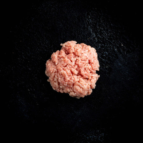 a pink donut sitting on top of a black table 