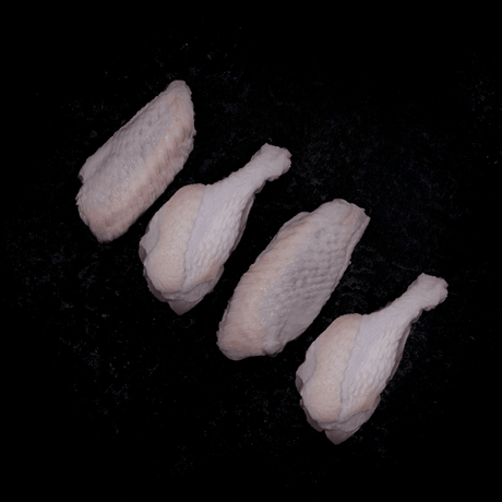 a group of white teddy bears sitting on the ground 