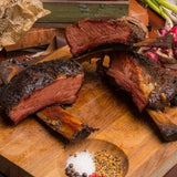 a close up of a plate of food on a wooden table 